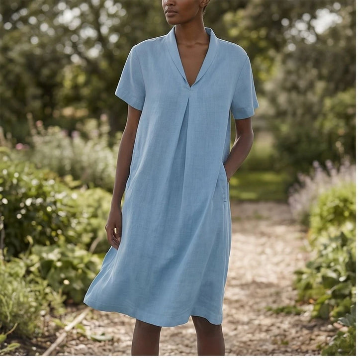 Model wearing Blue Women's Short-sleeved Cotton and Linen Dress V-neck Loose Large Size Casual Vacation Street Long Dress with Pockets outdoors