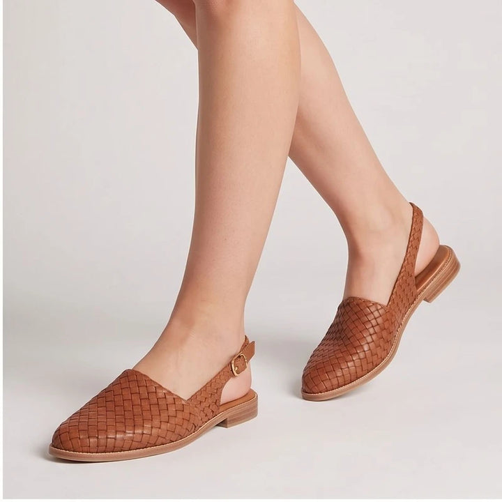 Model wearing Beige woven loafers in a studio