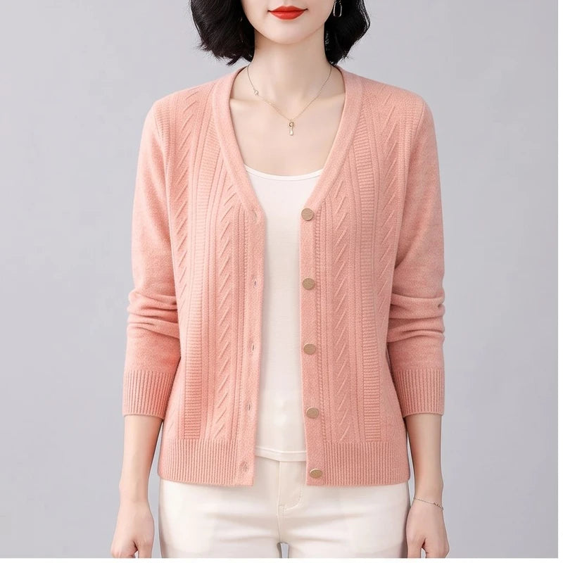 Model wearing Pink knitted cardigan in a studio