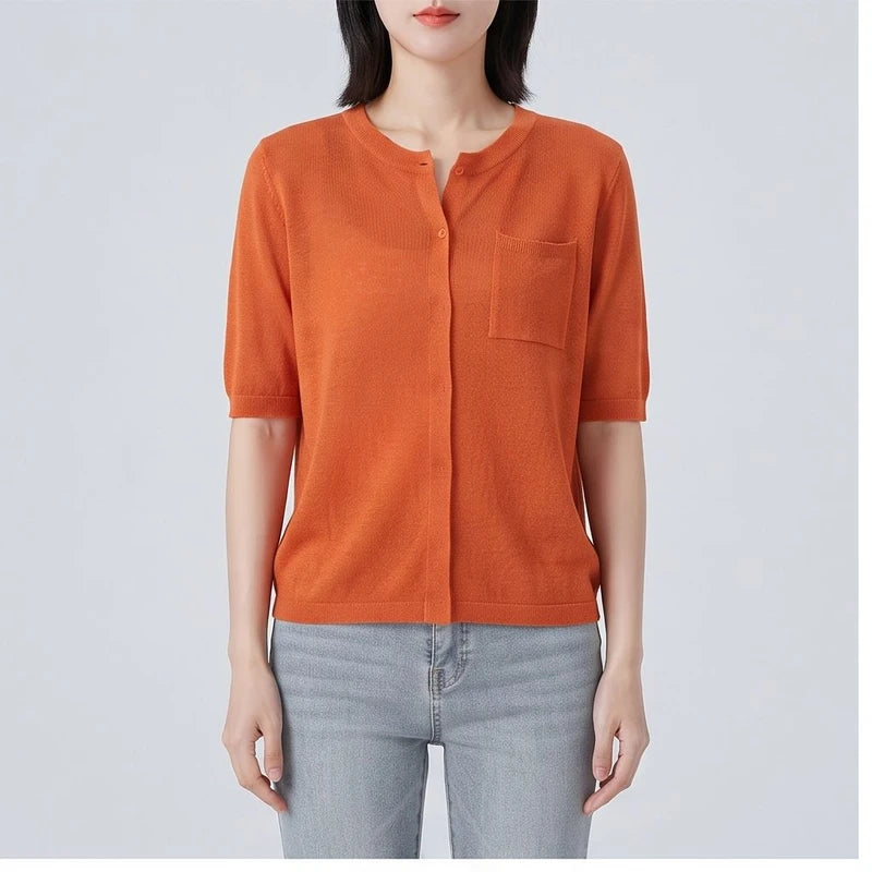 Model wearing Orange cardigan in a studio