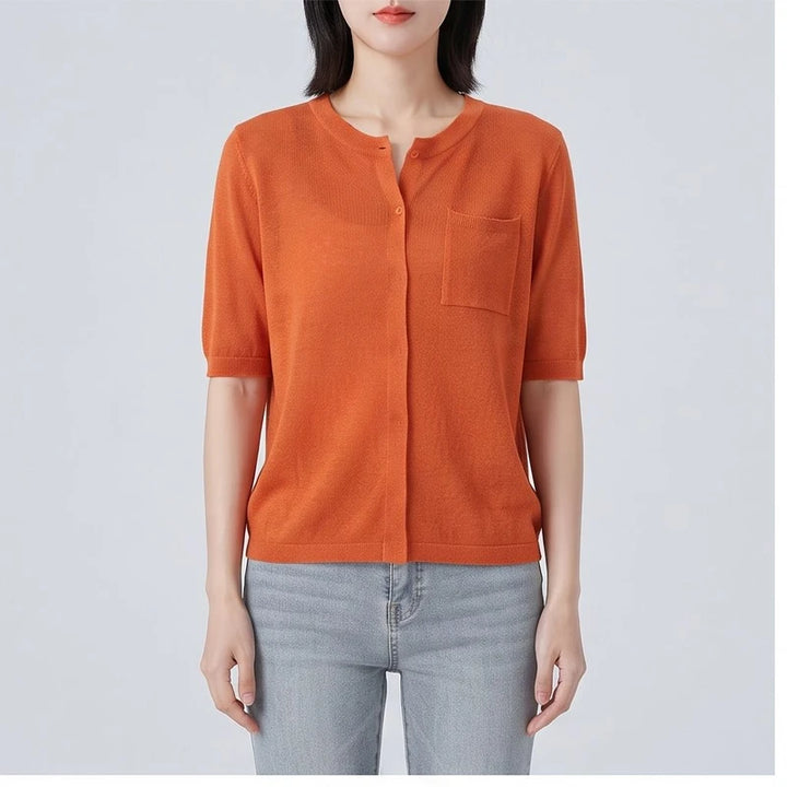 Model wearing Orange cardigan in a studio