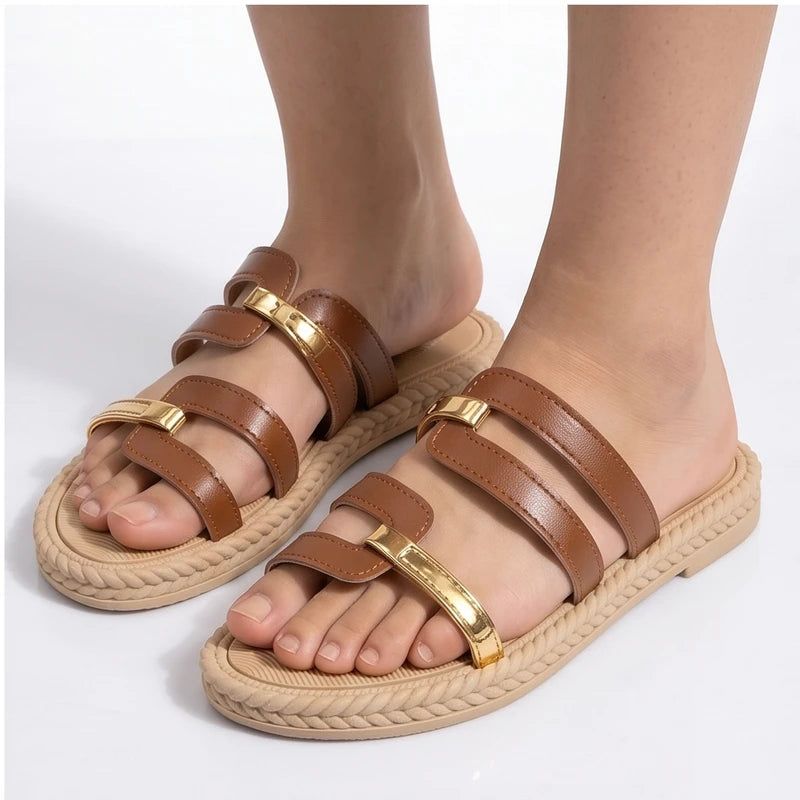 Brown leather slide sandals with gold accents and braided soles.
