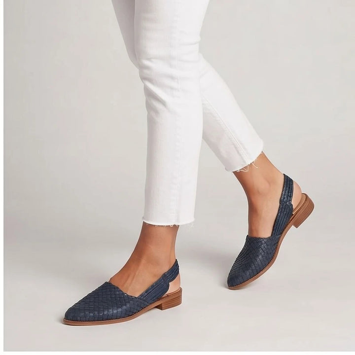 Model wearing Black woven loafers in a studio