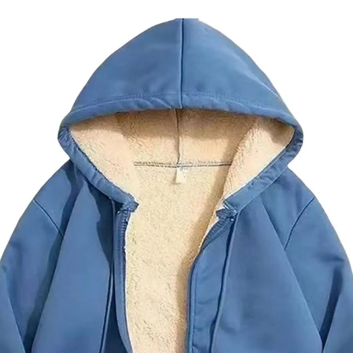 Close-up of a blue hooded jacket with a partially open zipper revealing its creamy white fleece lining.