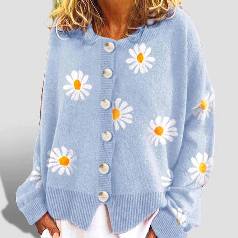 Blue knit cardigan on an off-gray studio background