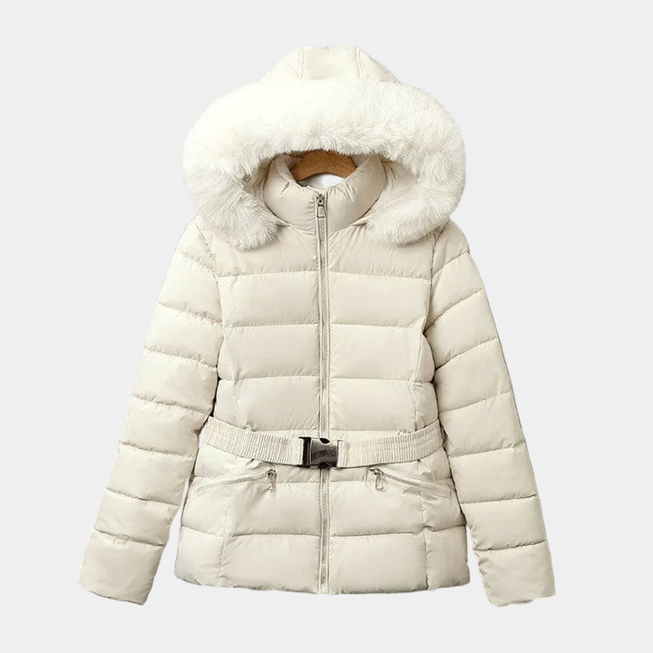 Cream short puffer jacket with a faux fur-trimmed hood and an elastic belted waist, hanging on a gray wall.
