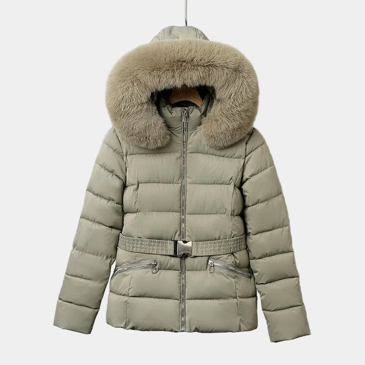 Light gray belted puffer jacket with a large tan faux fur trimmed hood, visible zippers, and a subtle quilted pattern.