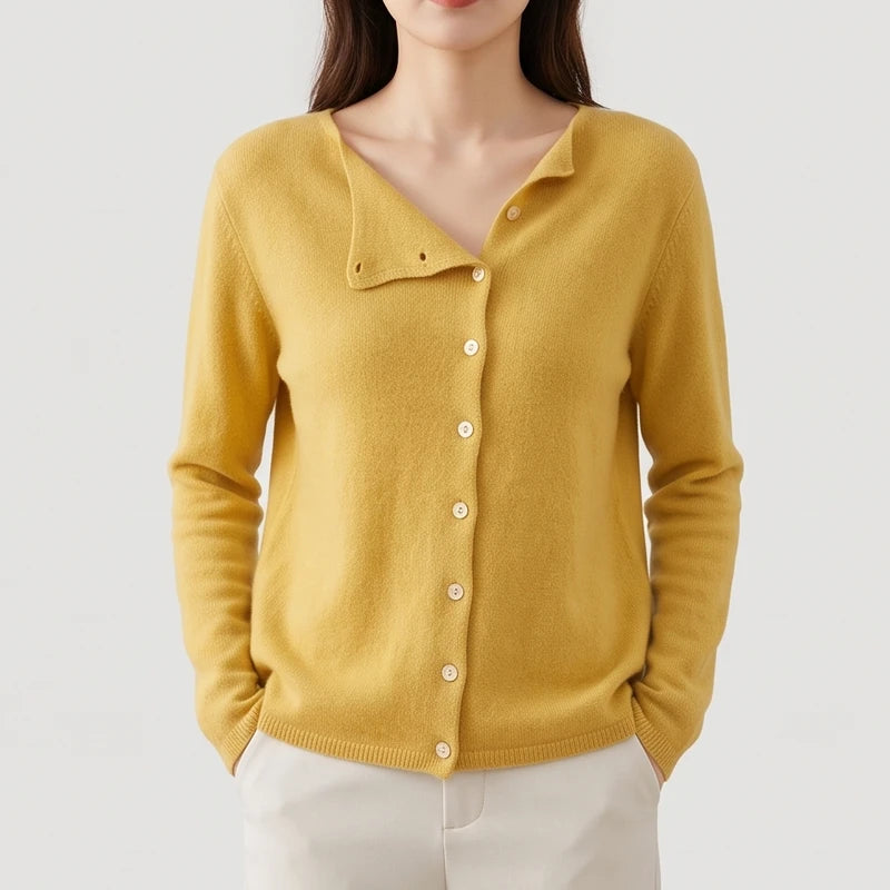 Woman wearing a mustard yellow knit cardigan with an asymmetrical V-neck and a full button-front closure.