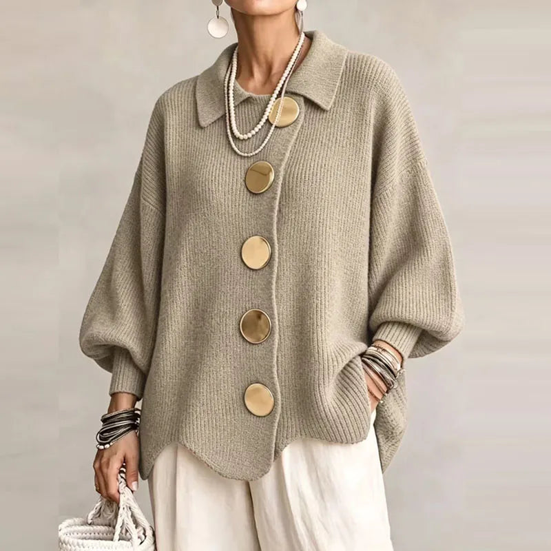Woman wearing a relaxed-fit light brown knit cardigan with a collar, large gold buttons, and puffed sleeves.