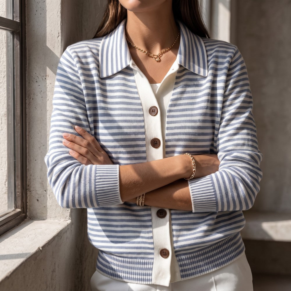 Woman wearing a blue and white striped knit cardigan with a ribbed hem and brown buttons, arms crossed.