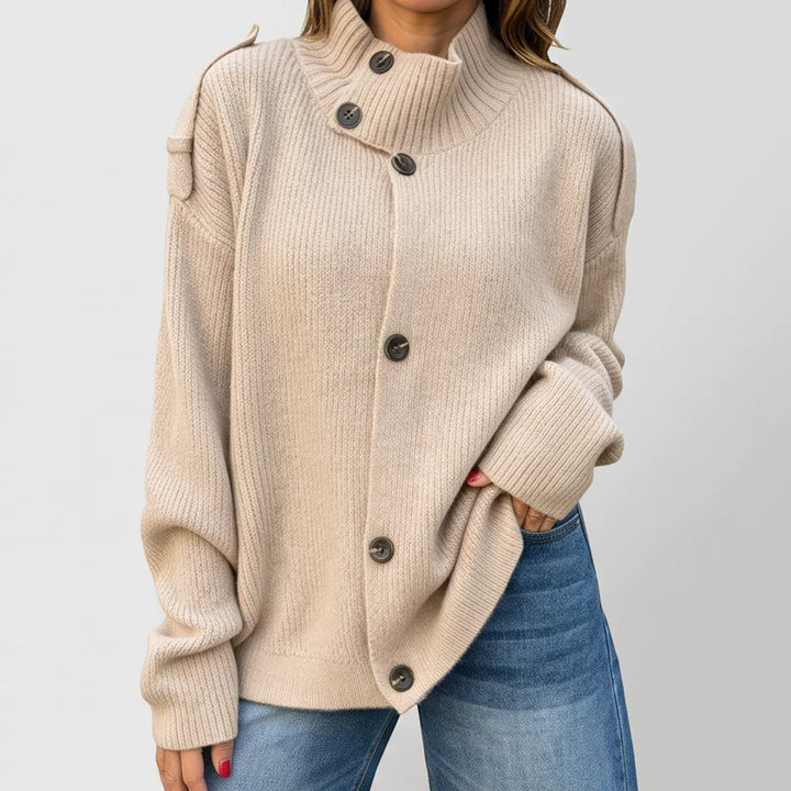 Apricot knit cardigan on an off-gray studio background
