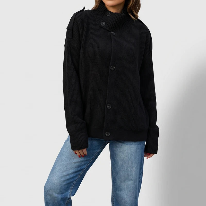Black knit cardigan on an off-gray studio background