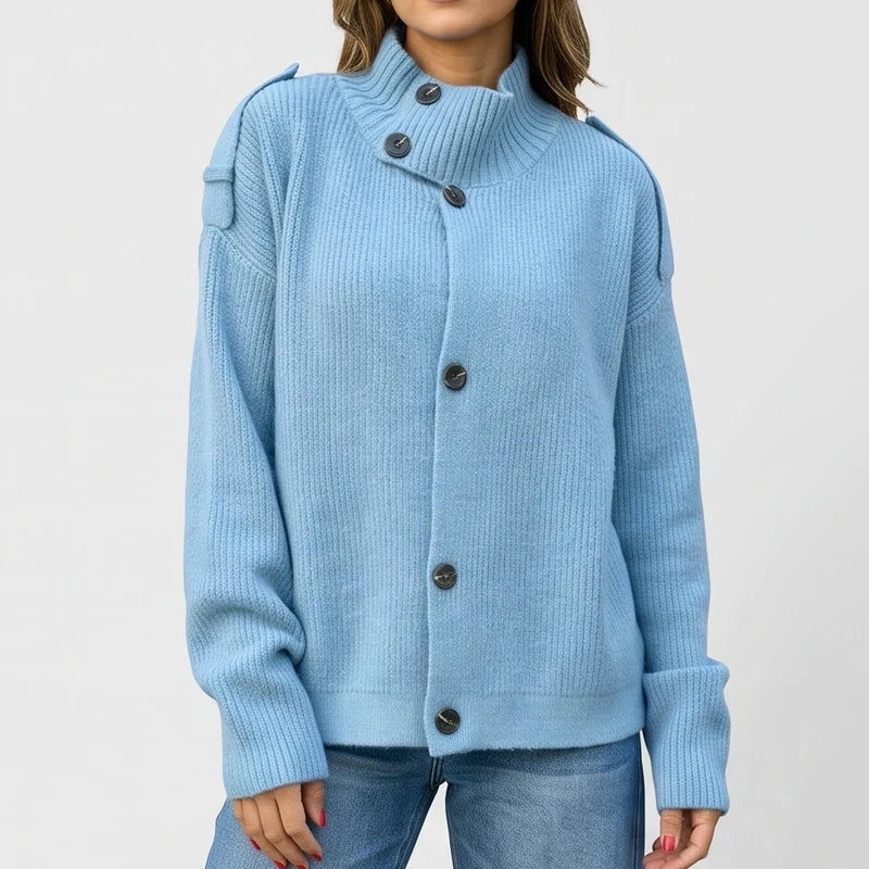 Blue knit cardigan on an off-gray studio background