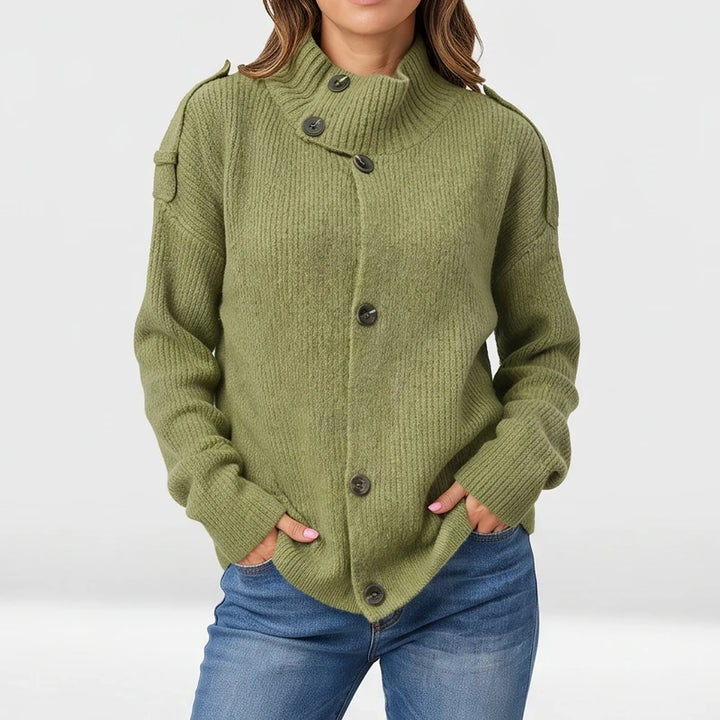 Green knit cardigan on an off-gray studio background