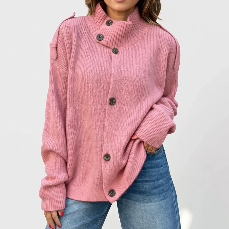 Pink knit cardigan on an off-gray studio background