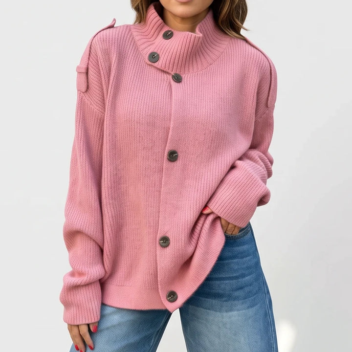 Pink knit cardigan on an off-gray studio background