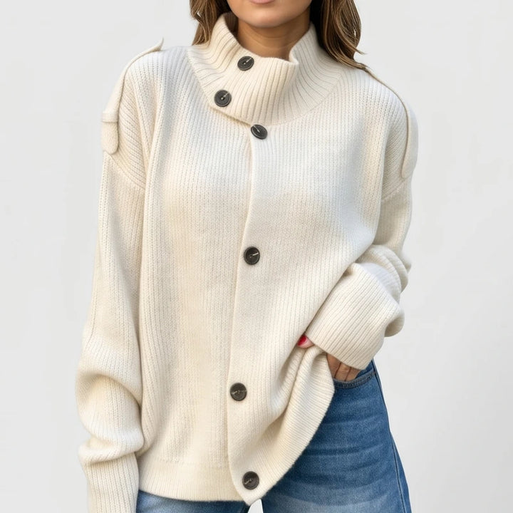 White knit cardigan on an off-gray studio background