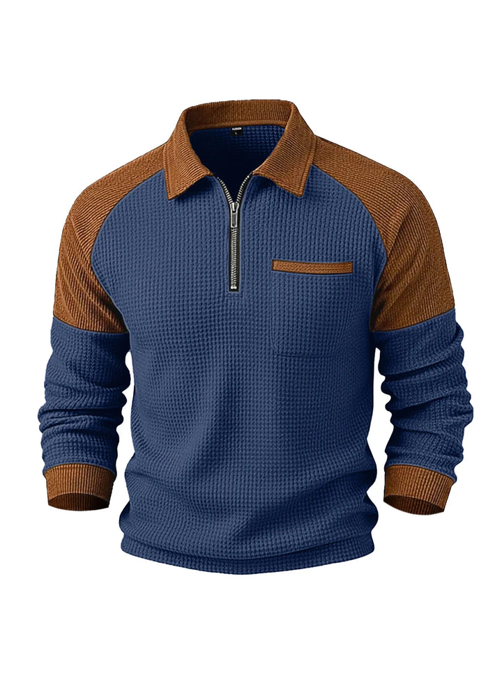 Blue waffle-knit half-zip top with a brown ribbed collar, sleeves, and chest pocket trim on a white background.
