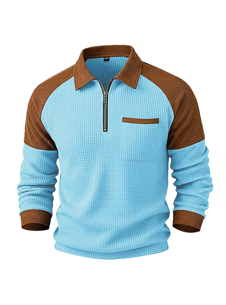 Two-toned half-zip knit sweatshirt in light blue waffle texture with brown ribbed collar, shoulders, cuffs, and chest pocket trim.
