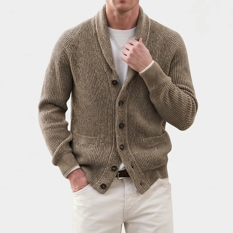 Man wearing a textured, ribbed brown knit cardigan with a shawl collar, dark buttons, and two front pockets.
