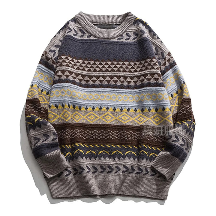 Flat lay of a grey knit sweater with horizontal bands of geometric patterns in brown, blue, yellow, and black.