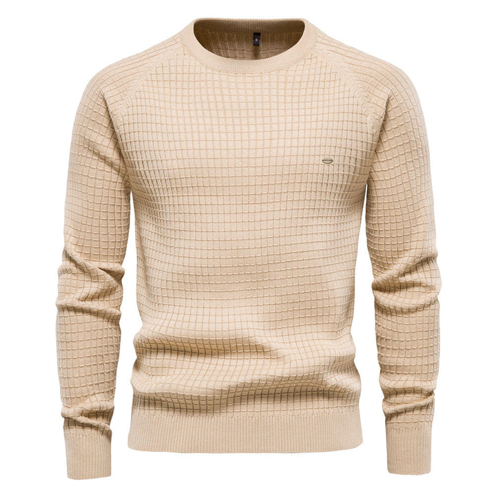 Light beige waffle knit sweater with a crew neck, ribbed cuffs, and a matching ribbed hem shown on a plain white background.