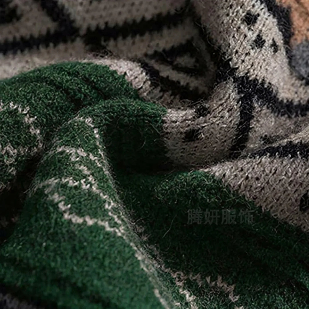 Close-up of a dark green, grey, and black knit sweater with a fuzzy texture and Nordic-style patterns.