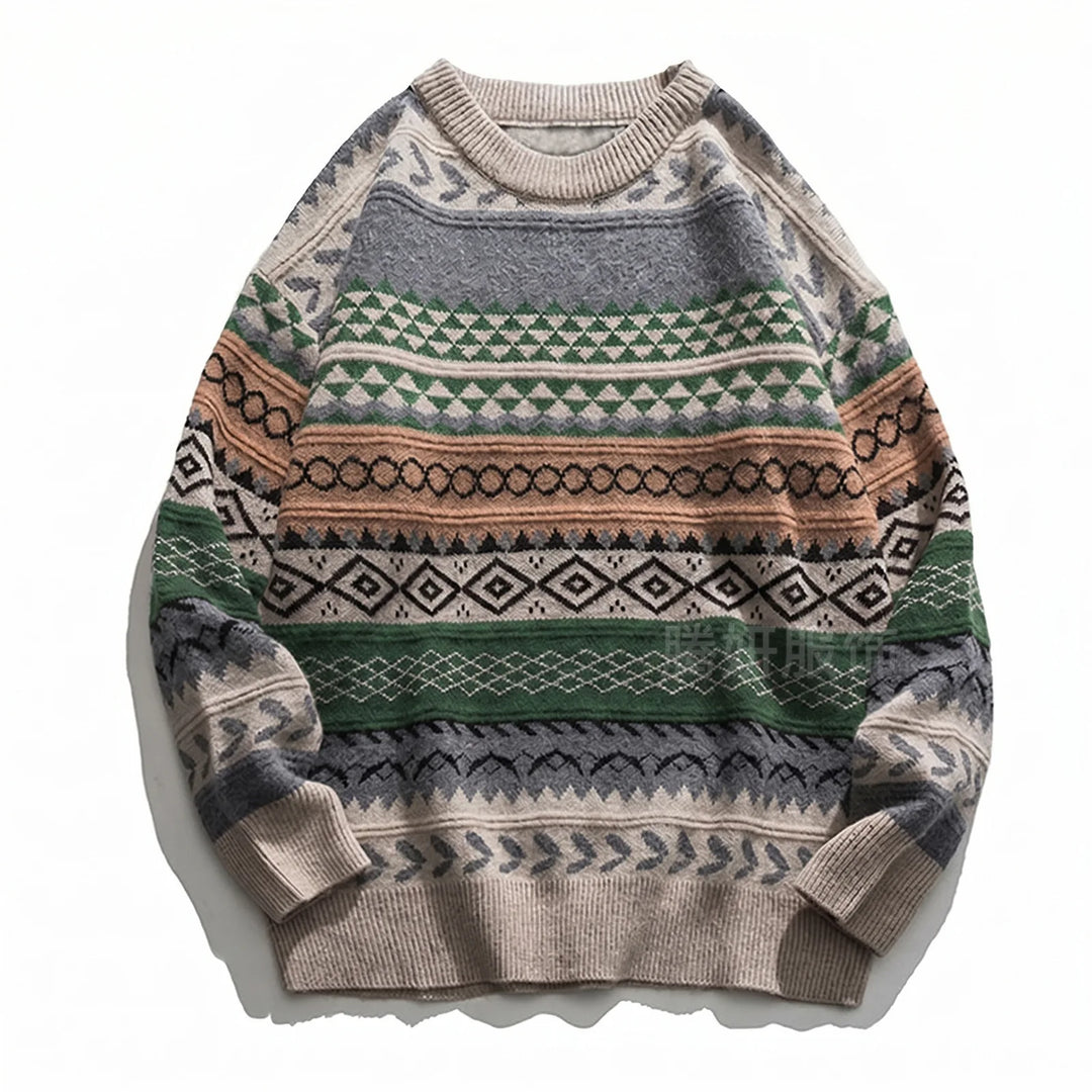 Flat lay of a beige, grey, and green knit sweater featuring a geometric, fair isle pattern with black and brown accents.