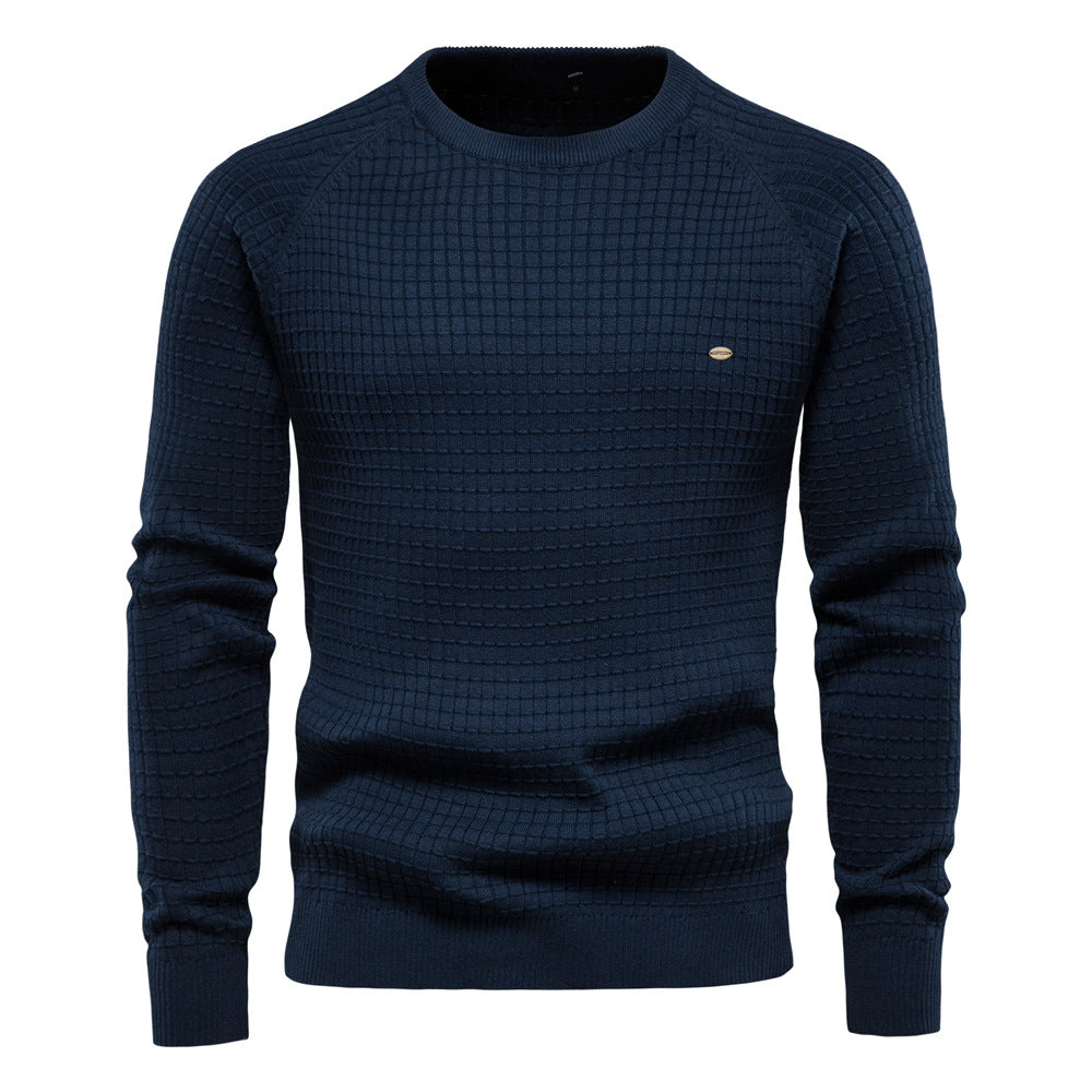 Navy blue waffle knit sweater with raglan sleeves and a small oval emblem on the chest.