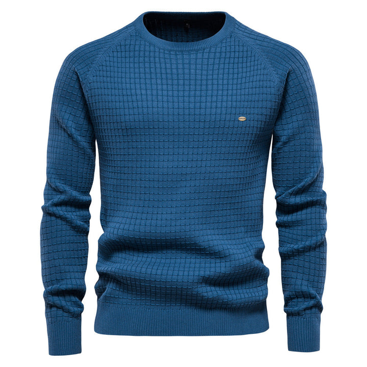 Front view of a men's blue crewneck sweater with a waffle knit texture and ribbed cuffs, collar, and hem.
