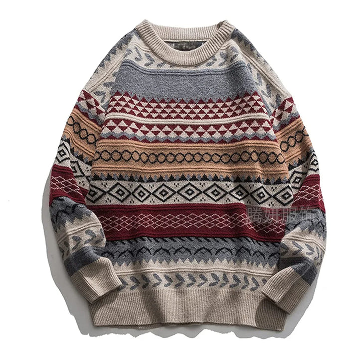 Flat lay of a chunky knit sweater featuring geometric patterns in beige, grey, red, and tan.