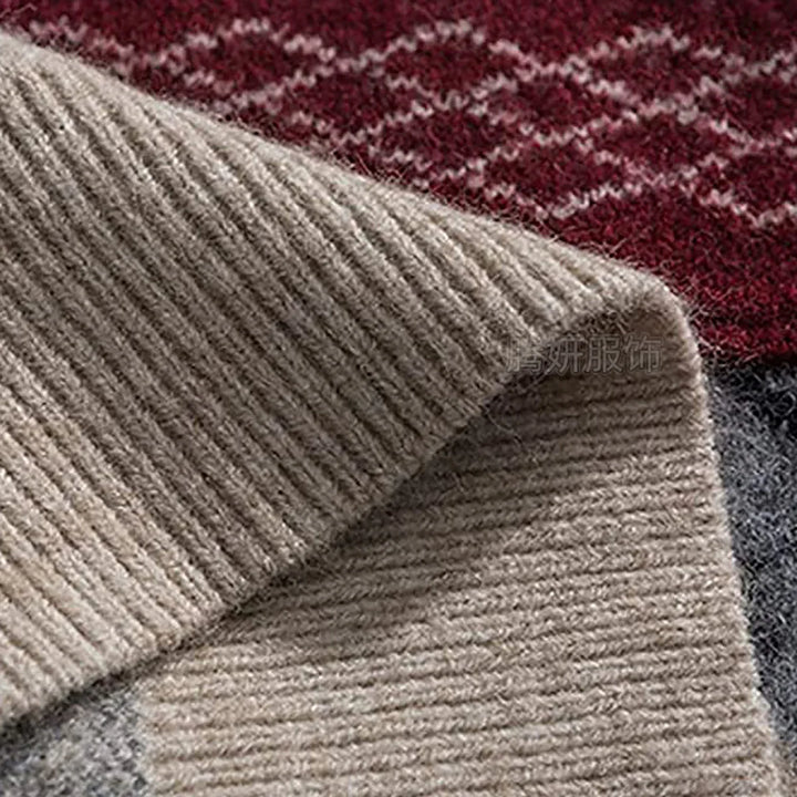 Close-up of folded beige ribbed knit fabric, showing its soft texture against dark red and gray patterned material.