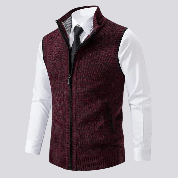 Red and black speckled knit vest with a high collar, full zipper, and ribbed hem, worn over a white shirt and tie.