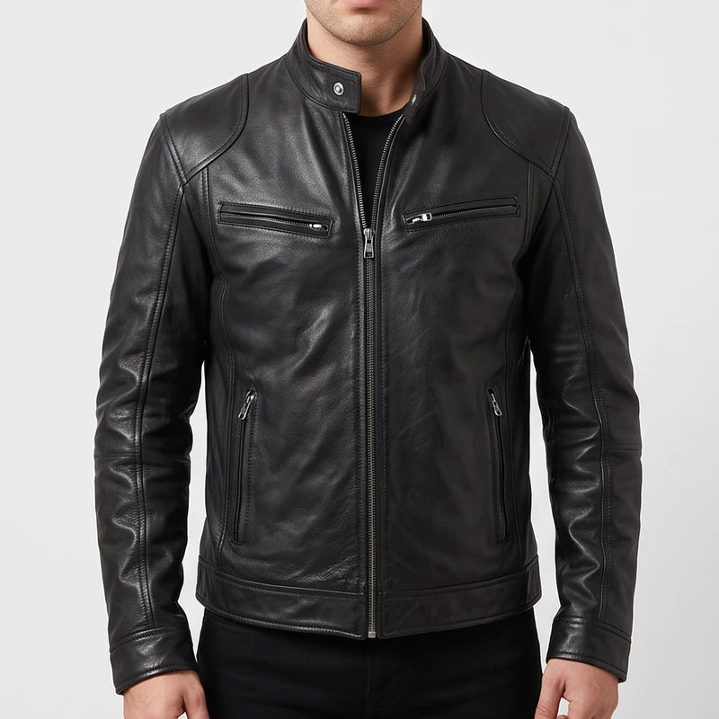 Man wearing a fitted black leather biker jacket with zippered pockets and a snap collar against a plain studio background.