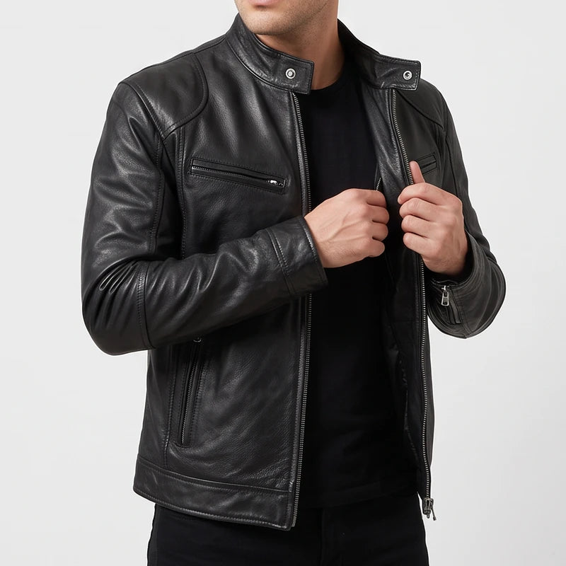 Man wearing an unzipped black leather biker jacket featuring a snap collar and zippered pockets over a dark t-shirt.
