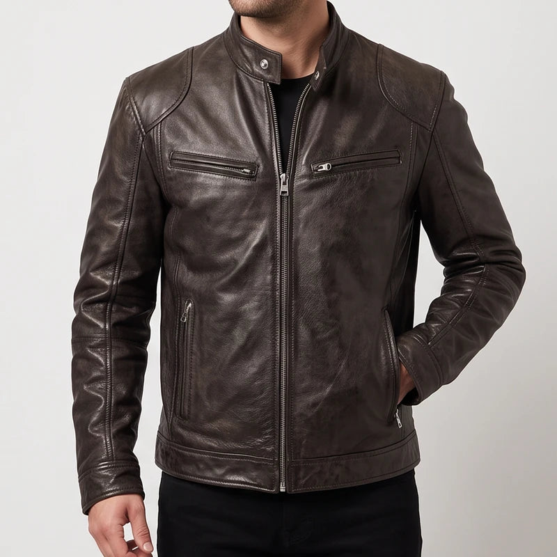 Man wearing a fitted dark brown leather jacket with multiple zippered pockets and a snap collar against a white background.