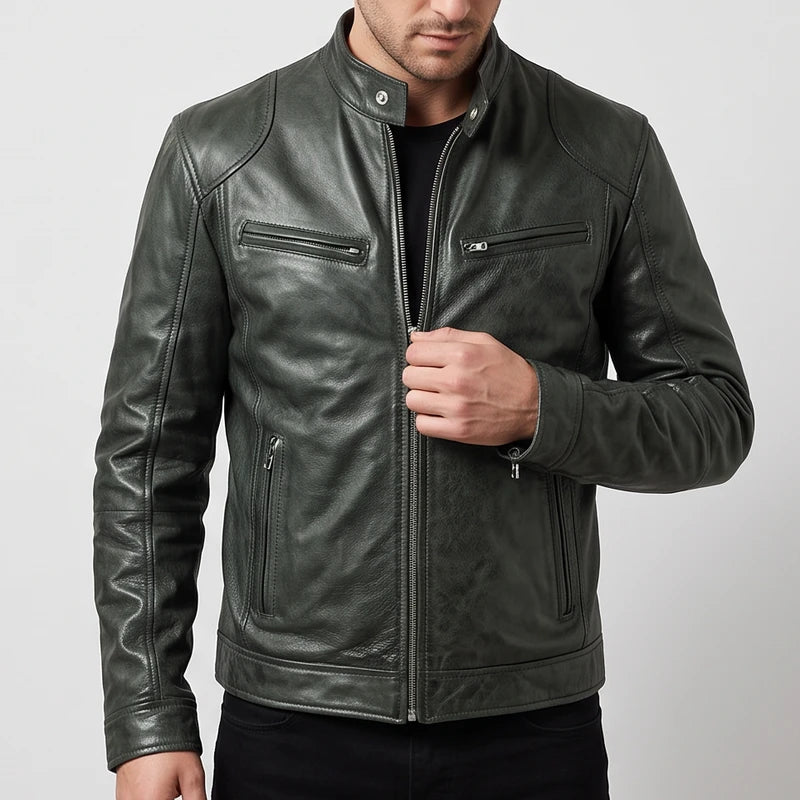 Man wearing a dark olive leather biker jacket with zippered pockets and a snap-tab collar against a plain background.