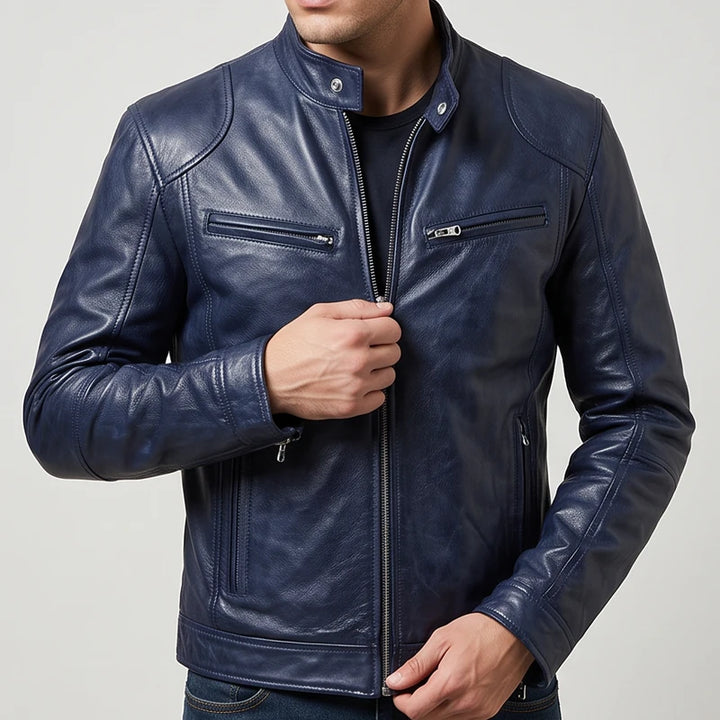 Man wearing a navy blue leather biker jacket with a mandarin collar, multiple zip pockets, and front zip closure.