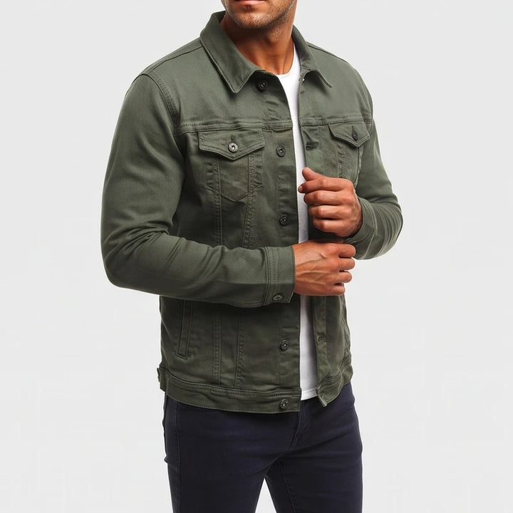 Man wearing a dark olive green long sleeve jacket with chest pockets, adjusting the cuff over a white shirt.
