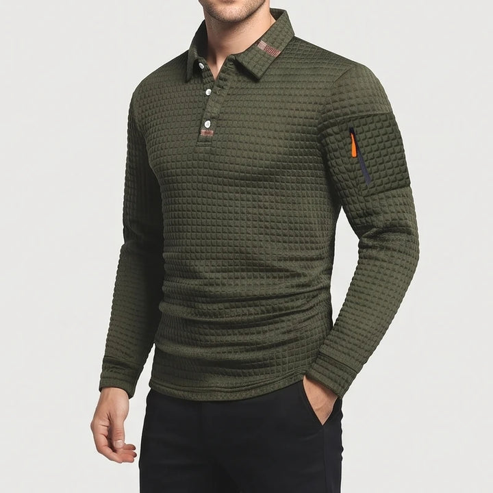 Man wearing a textured olive green long-sleeve polo shirt with white buttons and a zippered arm pocket.