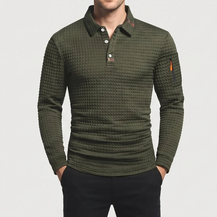 Man wearing an olive green long-sleeve polo shirt with a textured waffle knit and a zippered arm pocket.