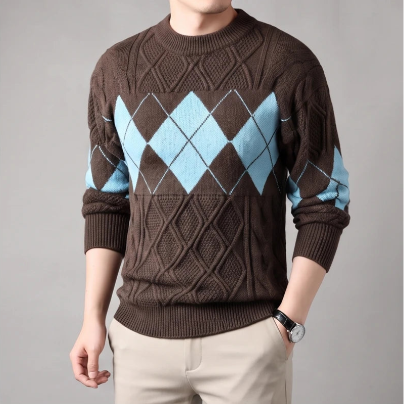Man wearing a brown argyle knit sweater with light blue diamonds, beige pants, and a dark watch.