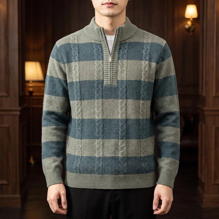 Man wearing a half-zip sweater with green and blue horizontal stripes and cable-knit details.