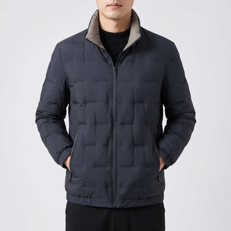 Man wearing a dark navy puffer jacket with a light gray collar, full zipper, and ribbed hem, hands in pockets.