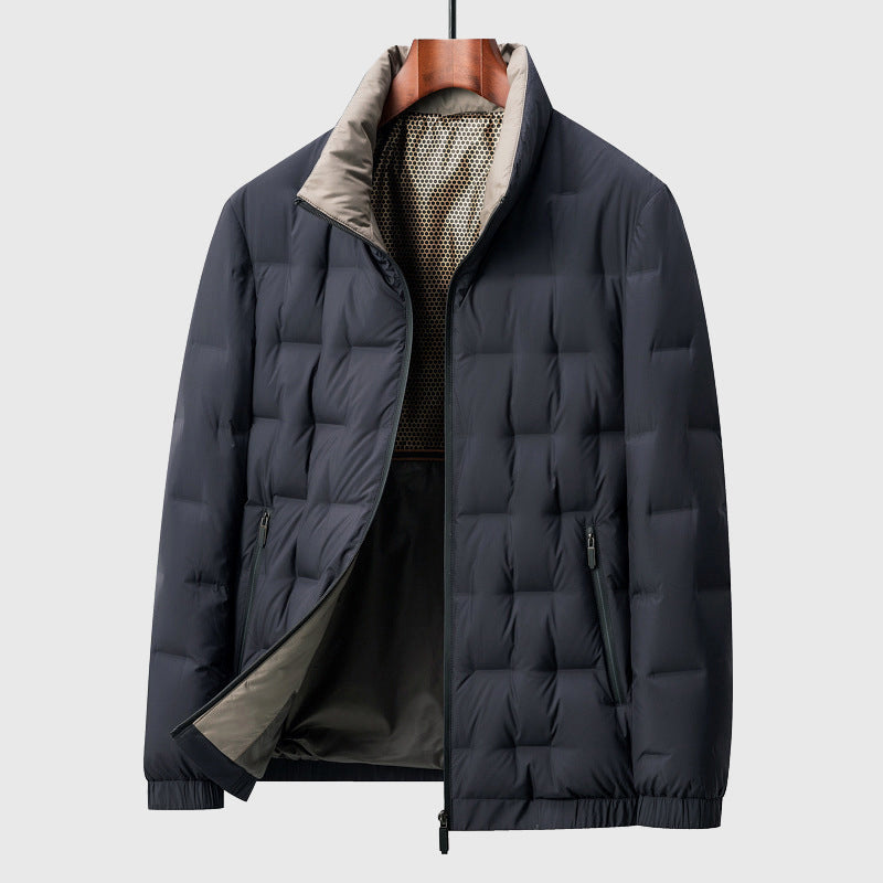 Dark blue quilted puffer jacket with a light grey stand-up collar, partially unzipped, hanging on a wooden hanger.