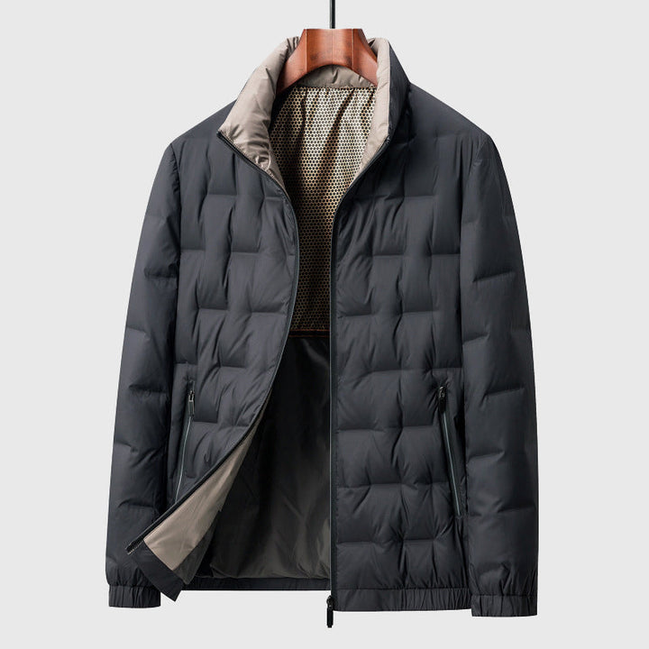 Dark gray quilted puffer jacket with a stand-up beige collar and visible mesh inner lining, displayed on a wooden hanger.