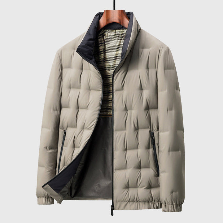 Light tan puffer jacket on a hanger, featuring a stand collar, black zipper, ribbed cuffs, and quilted pattern.