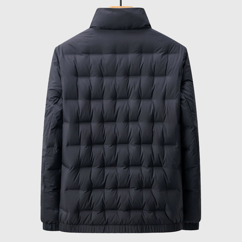 Back view of a dark navy puffer jacket with a mock neck and square quilted baffles, hanging on a hanger.
