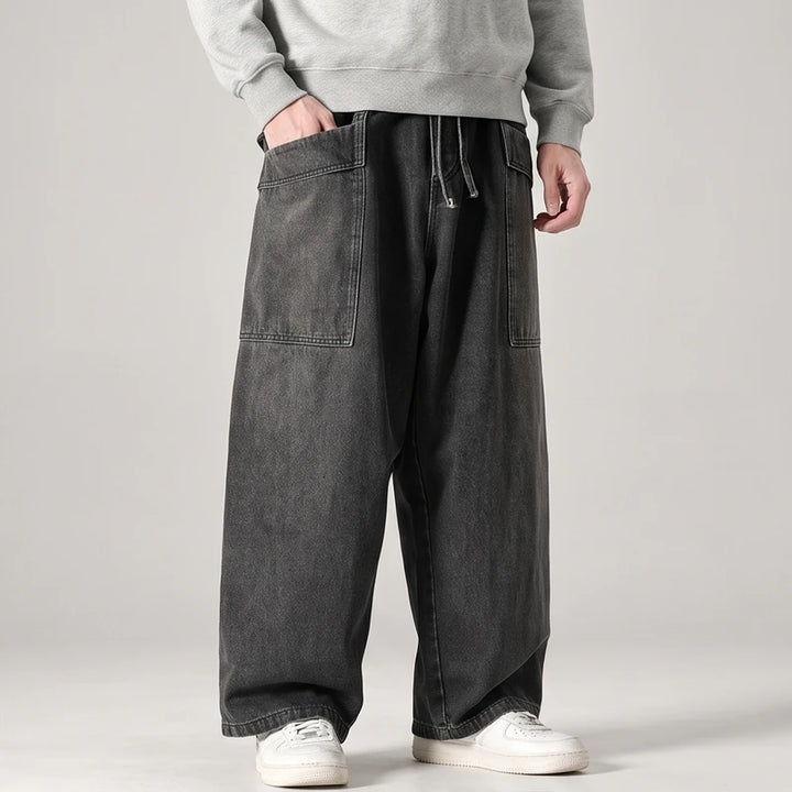 Black jeans on an off-gray studio background
