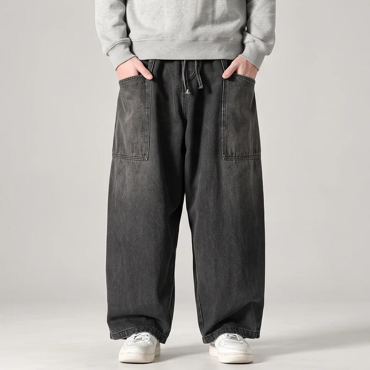 Black jeans on an off-gray studio background - 2